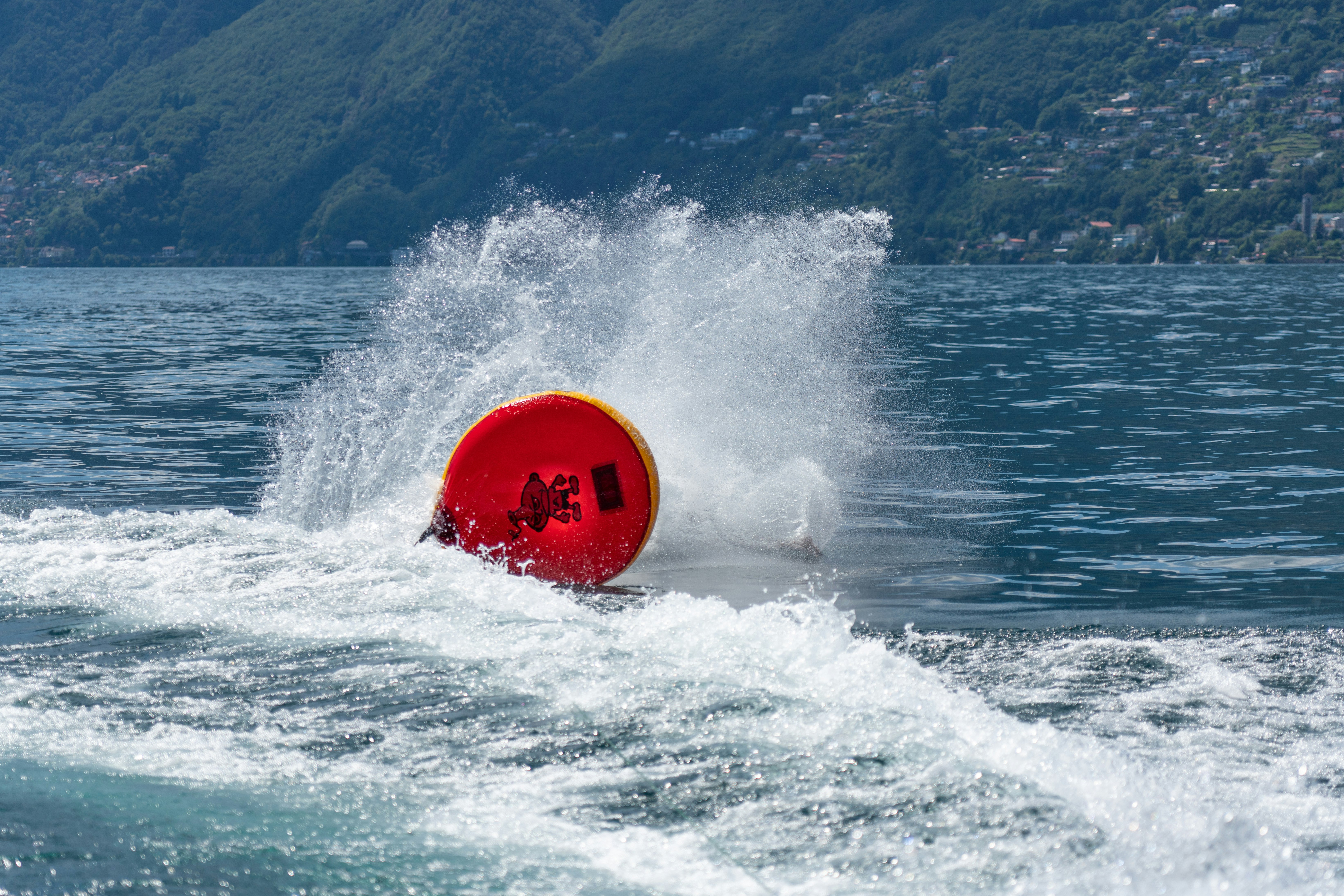 red and yellow surfboard on sea waves during daytime